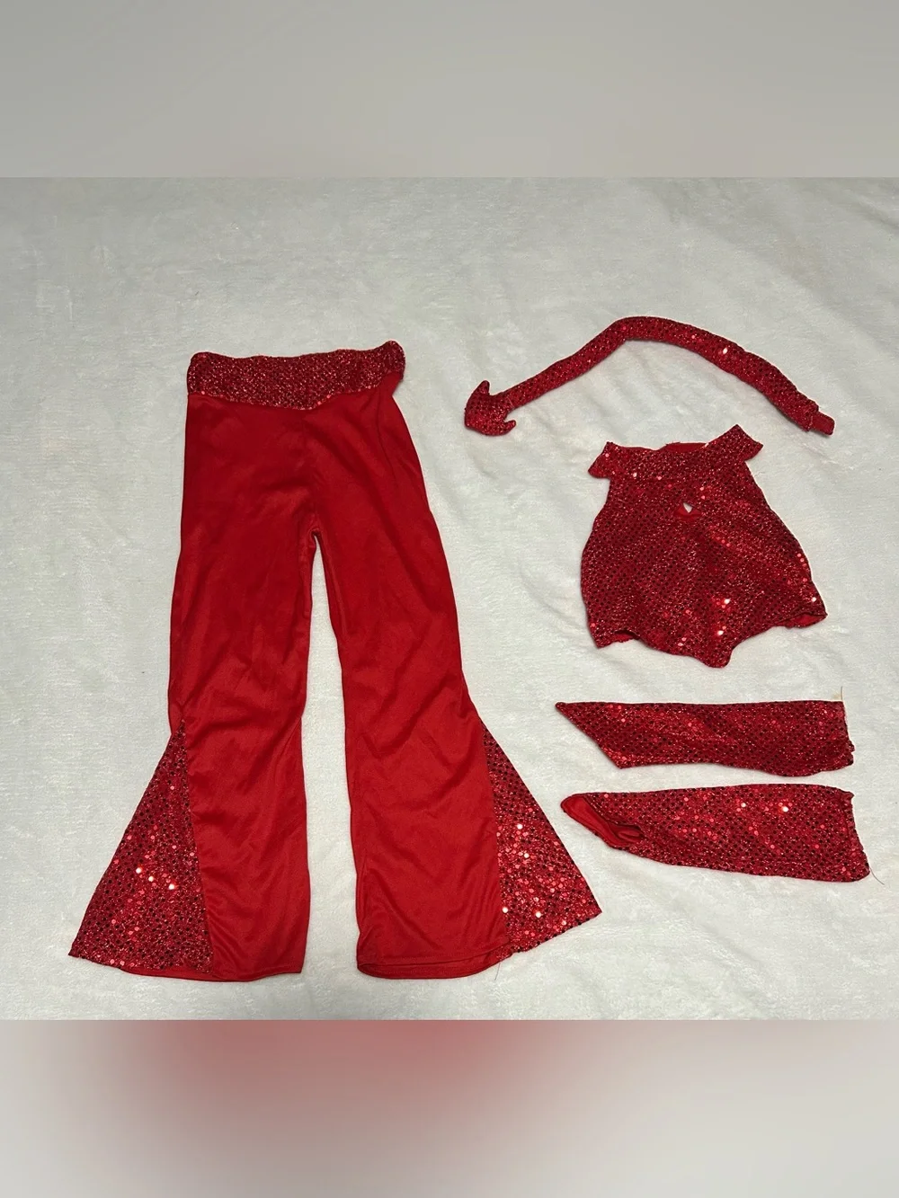 Kids Red Sequin Devil Costume Set comes with pants, top, gloves and pitchfork.